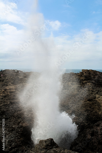 Close up of the big blow hole with water fountain in the picturesque village of Kiama near Jervis Bay on a sunny spring day (Jervis Bay, Australia)