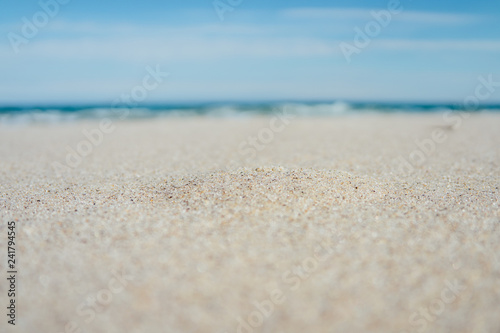 Close-up of sandy beach with blue sea