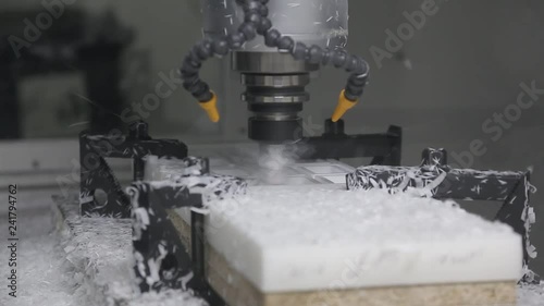 Industrial cnc drill is drilling a detail in to the plastic plank