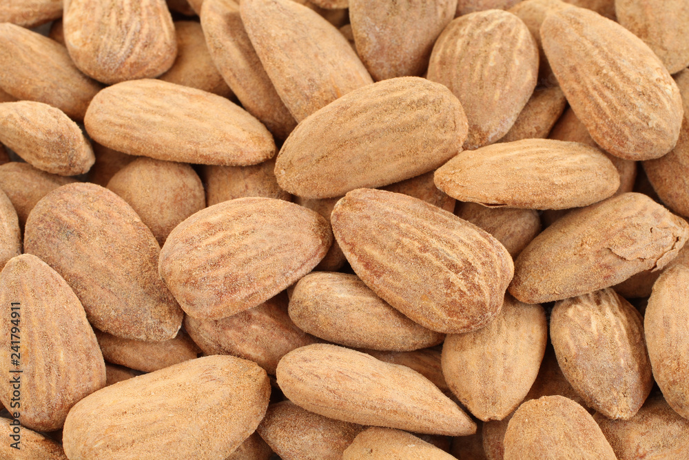 Food background - big shelled roasted salted almonds situated arbitrarily Food background - big shelled roasted salted almonds situated arbitrarily