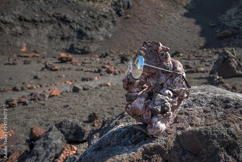 Lanzarote volcanic island of the Canary archipelago, Spain. The ancient solidified lava formations are reflected on the iconic objects of modern tourism