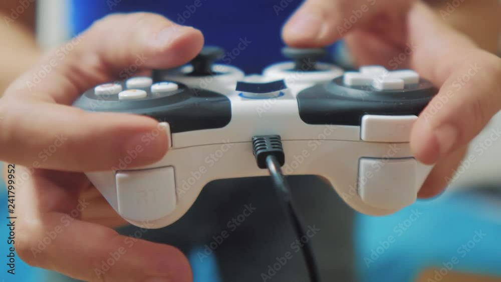 man playing gamepad hands video console on tv. Hand hold new joystick playing video console on tv. Gamer play game with gamepad controller. Gaming man holding simulator joypad. Person with keypad man playing gamepad hands video console on tv. Hand hold new joystick playing video console on tv. Gamer play game with gamepad controller. Gaming man holding simulator joypad. Person with keypad