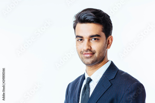 Smiling businessman in suit and tie, isolated on white studio background..