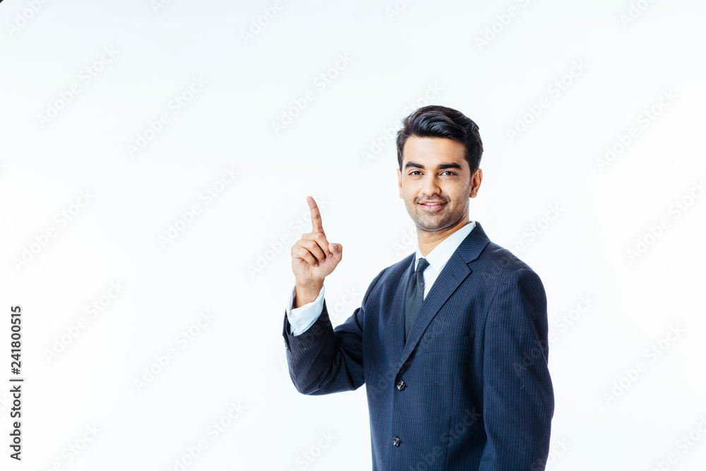 Portrait of a smiling, successful businessman in black suit and tie pointing up isolated on white background Portrait of a smiling, successful businessman in black suit and tie pointing up isolated on white background