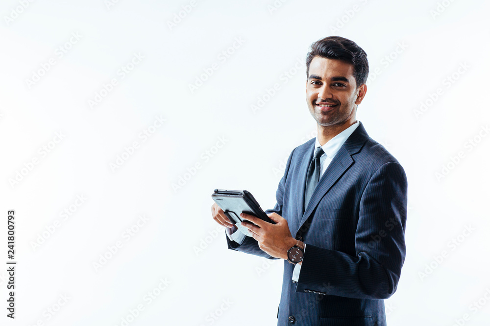 Portrait of man in business suit holding electronic tablet pad and smiling at camera, isolated on white background. Portrait of man in business suit holding electronic tablet pad and smiling at camera, isolated on white background.