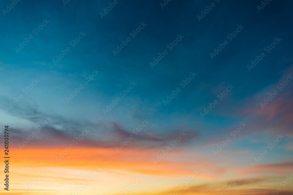 Sky blue and orange light of the sun through the clouds in the sky Sky blue and orange light of the sun through the clouds in the sky