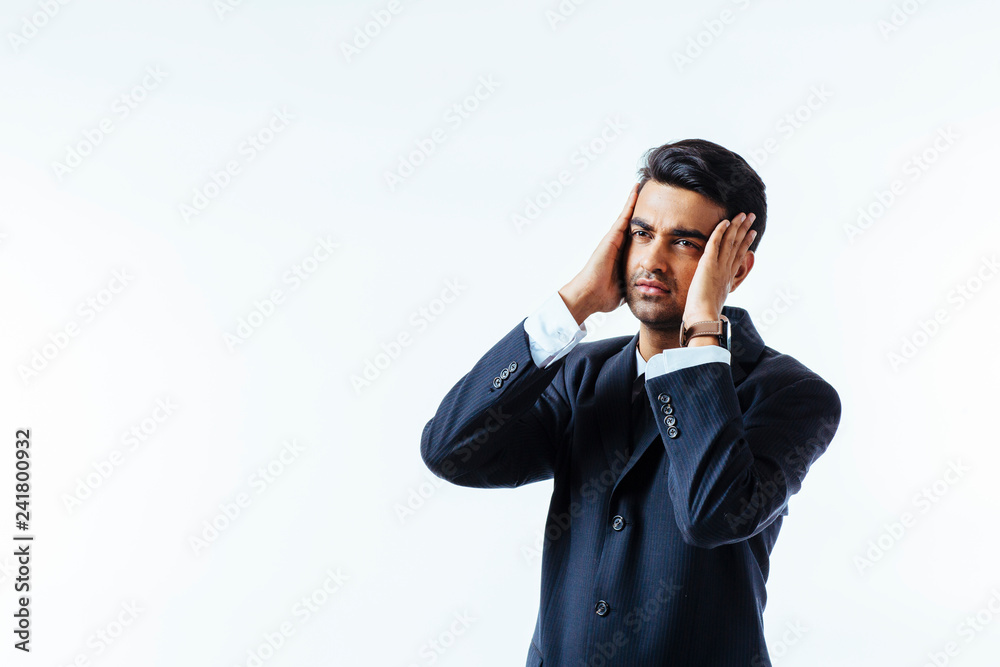 Portrait of a cool businessman holding his head in disbelief or in pain, isolated on white background.. Portrait of a cool businessman holding his head in disbelief or in pain, isolated on white background..