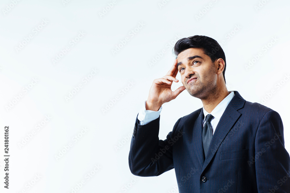 Portrait of a handsome businessman holding his head in disbelief, in pain or meditating, isolated on white background. Portrait of a handsome businessman holding his head in disbelief, in pain or meditating, isolated on white background.