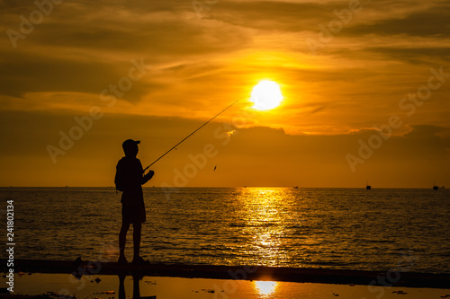 life portrait fishermen silhouette on the sea and the sunset over background evening time