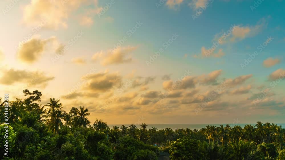 Clouds flying in the blue sky at colourful sunrise over trees and sea. 4k time lapse
Clouds flying in the blue sky at colourful sunrise over trees and sea. 4k time lapse