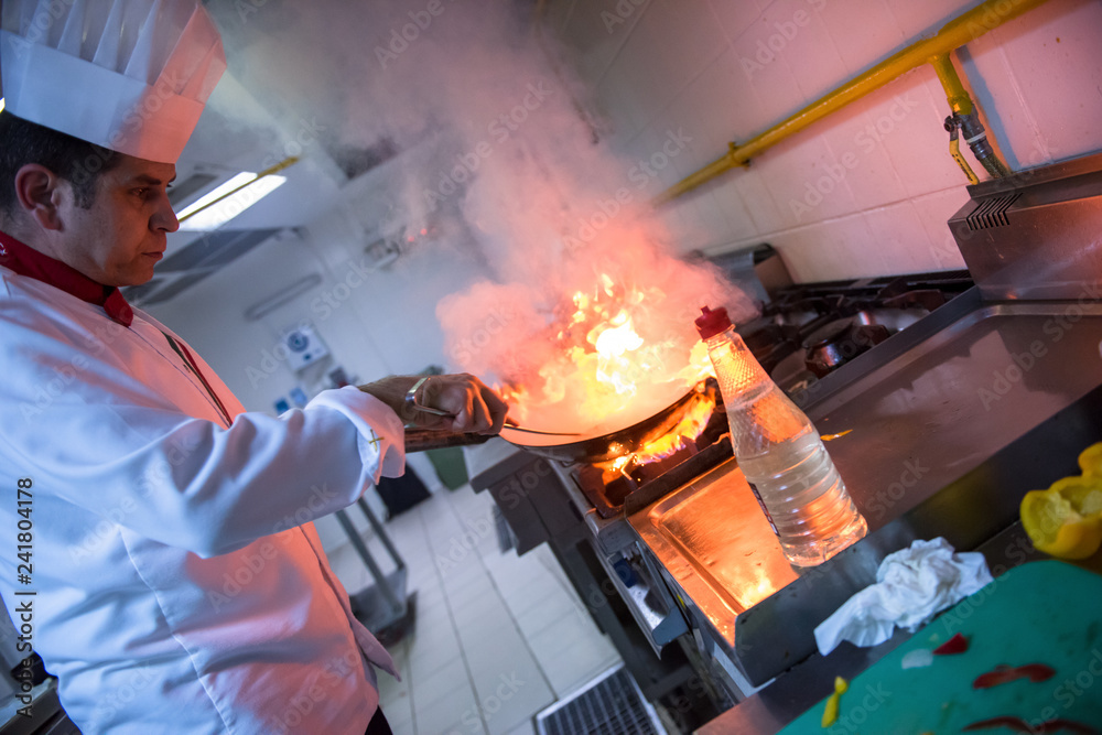 Chef doing flambe on food Chef doing flambe on food