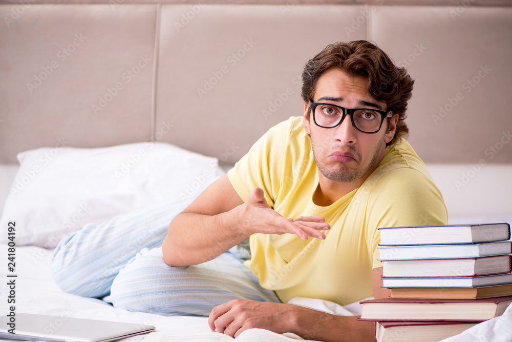 Young student studying in bed for exams Young student studying in bed for exams