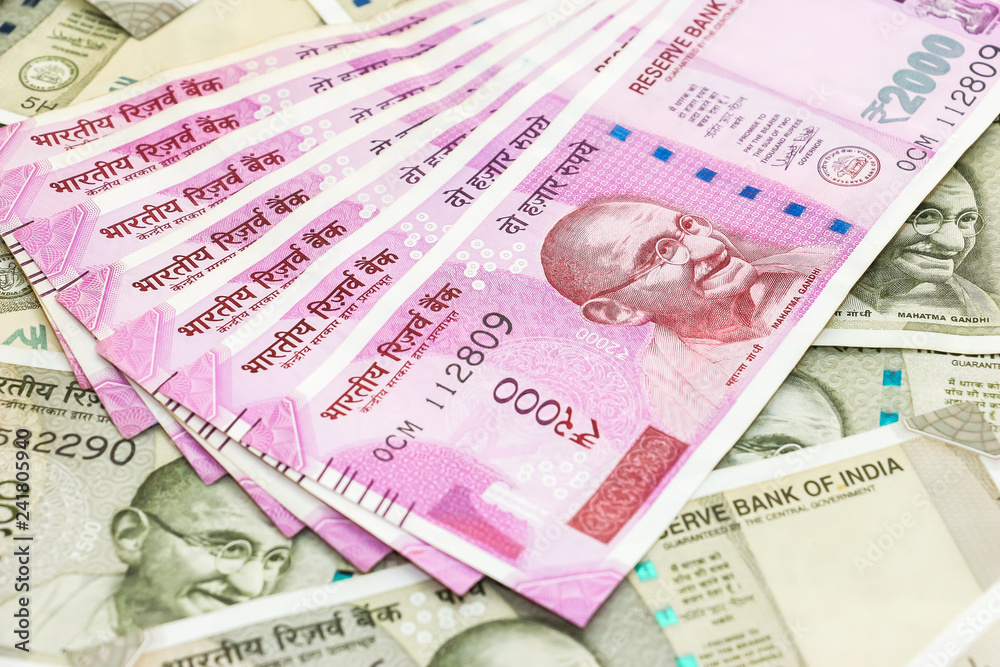 close up view of brand new 2000 indian rupees banknotes over 500 rupees  banknotes background. Stock Photo | Adobe Stock