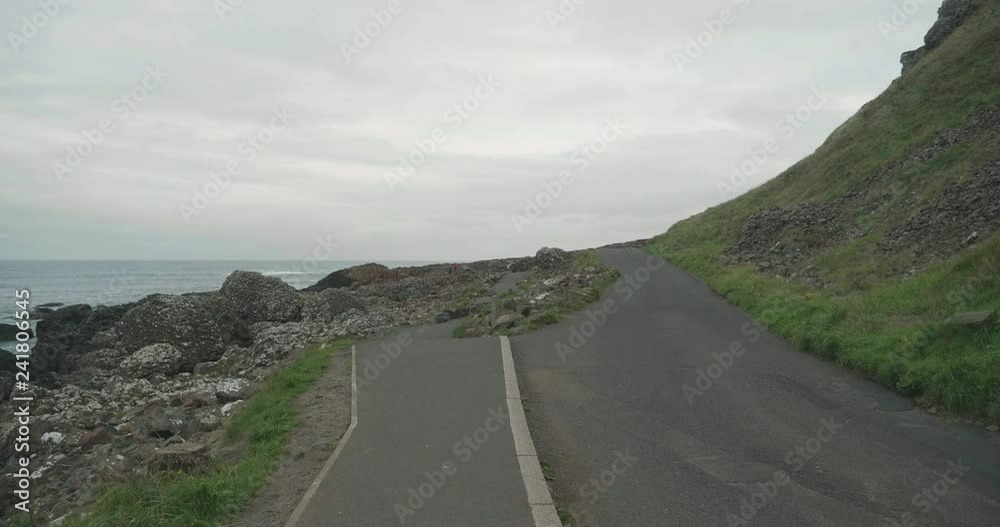 hand hold shoot waking on the countryside road in Northern coastline,Giant causeway,Northern Ireland hand hold shoot waking on the countryside road in Northern coastline,Giant causeway,Northern Ireland