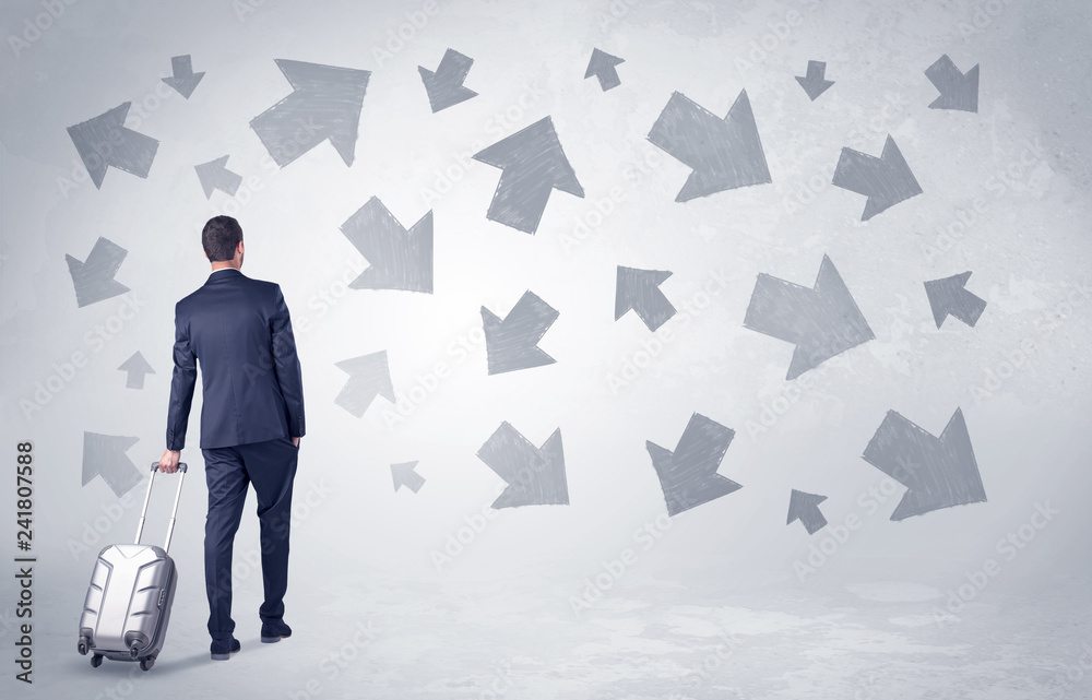 Obraz premium Businessman with back walking away with higgledy-piggledy arrows around 