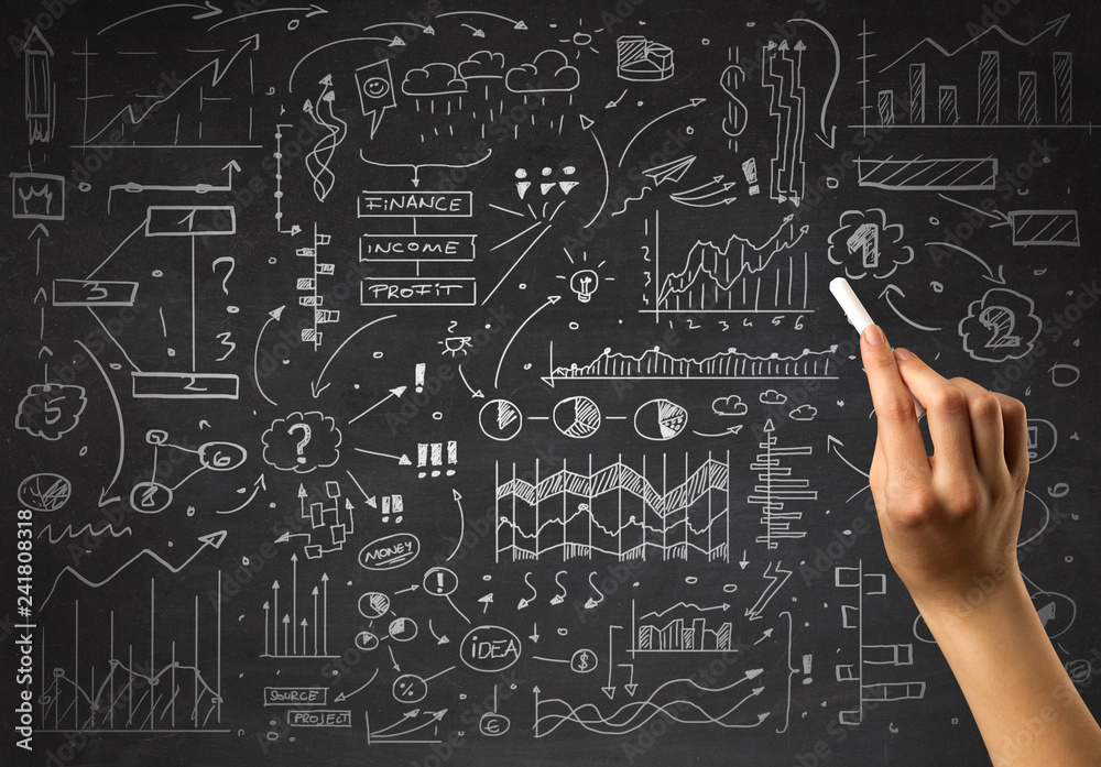 Female hand holding white chalk in front of a blackboard with a business plan drawn on it 