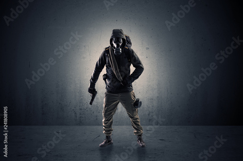Bad agent in a dark room with arms on his hand and gas mask 