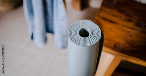 Rolled yoga mat in pastel color. Modern pastel gray blue color. Minimalism, home yoga practice concept