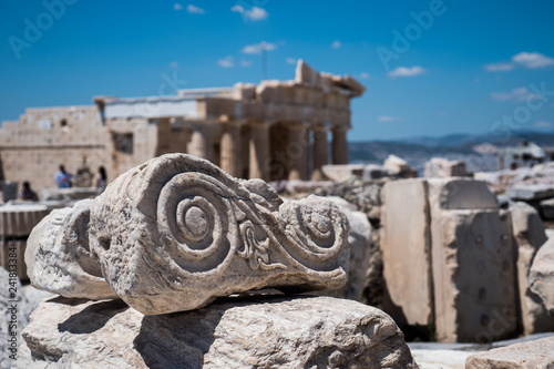Fragment from the ruins. With the Propyla in the background. At the Acropolis, Athens, Greece.
