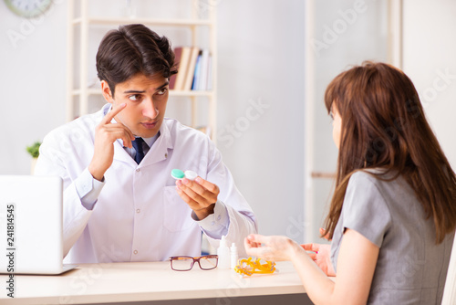 Young woman visiting male doctor ophthalmologist in hospital