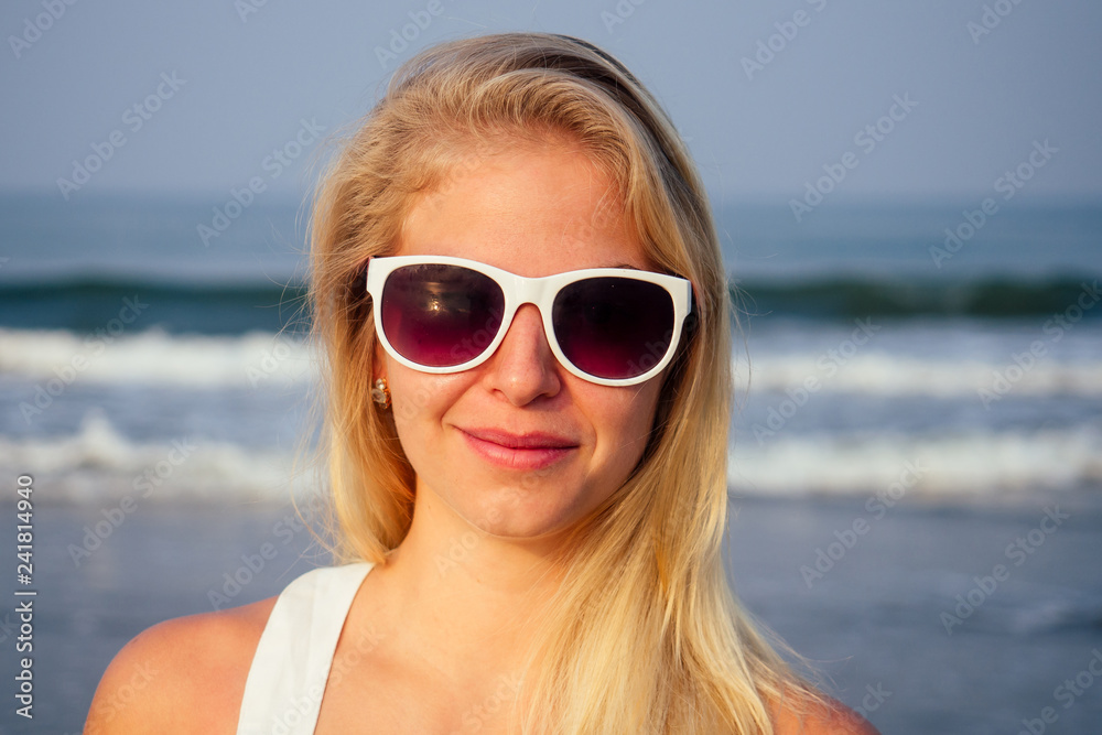 woman blonde in white glasses on the beach morning dawn portrait woman blonde in white glasses on the beach morning dawn portrait