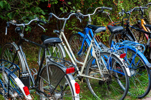 Amsterdam, The Netherlands - September 1, 2018: Dutch granny bikes lined up in a row. These types or styles of bikes are also referred to as station bikes, but for some, their only bike.