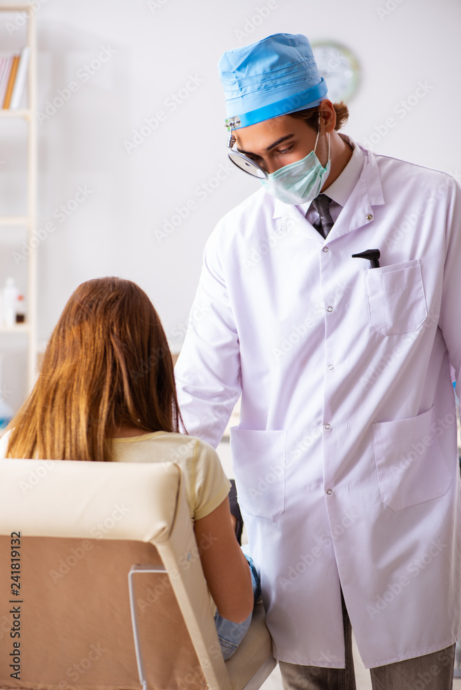 Young woman visting male doctor otolaryngologist Young woman visting male doctor otolaryngologist