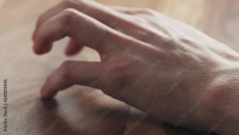 Young man hand waiting tapping fingers sitting at the table Young man hand waiting tapping fingers sitting at the table