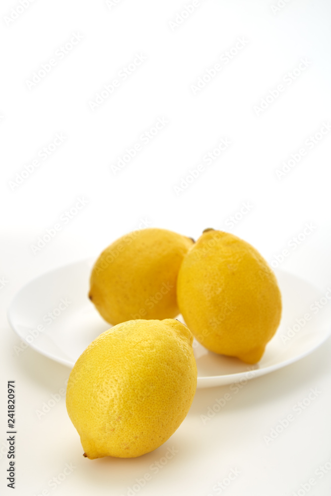 Lemons on a white plate Lemons on a white plate