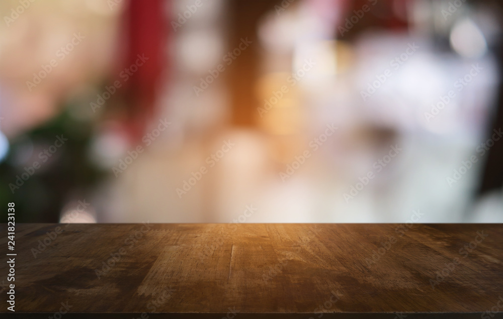 Empty dark wooden table in front of abstract blurred bokeh background of restaurant . can be used for display or montage your products.Mock up for space. Empty dark wooden table in front of abstract blurred bokeh background of restaurant . can be used for display or montage your products.Mock up for space.