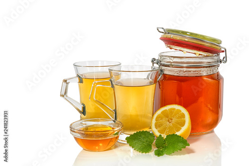 green tea with lemon and honey on white background