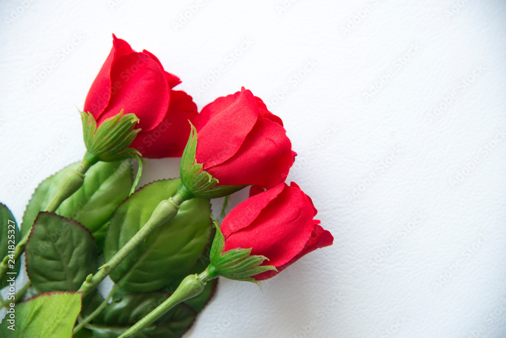 Plastic red rose on white  background.