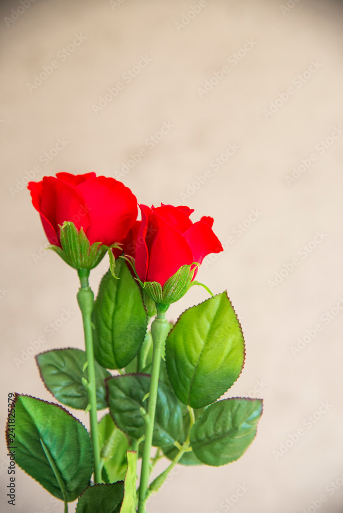 Plastic red rose on white  background.