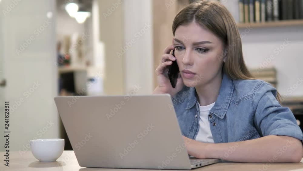Young Girl Talking on Phone and Discussing Progress Young Girl Talking on Phone and Discussing Progress