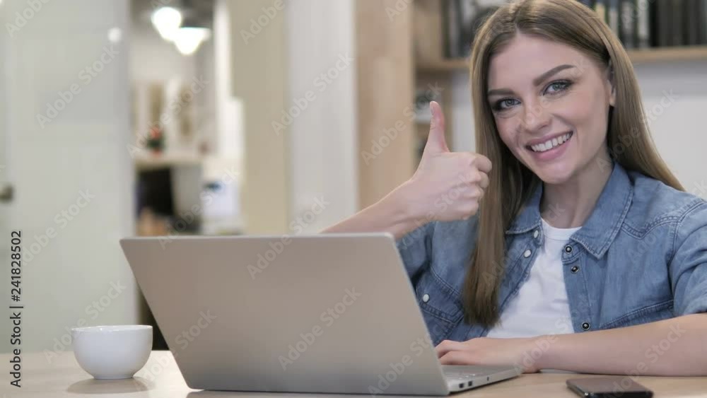 Thumbs Up by Creative Young Girl at Work