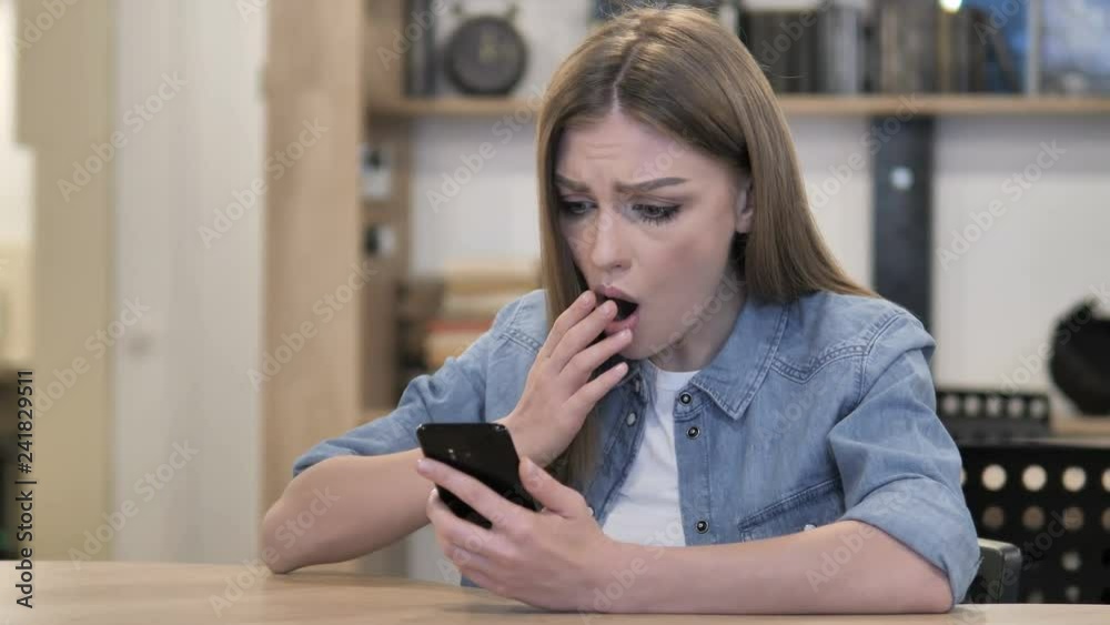 Wondering Creative Woman in Shock while Using Smartphone Wondering Creative Woman in Shock while Using Smartphone