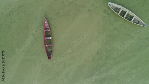 Aerial top view of an old wooden boat in a green lake photo