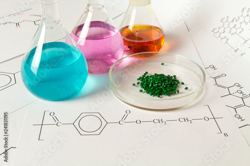 Obraz na plátně Plastic raw material in granules against the background of Chemical Laboratory and reagents