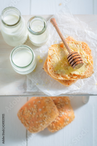 Homemade honey bun with milk on white table