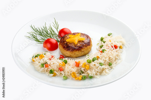 Children's menu. Fish cutlet with rice and vegetables. On white background photo