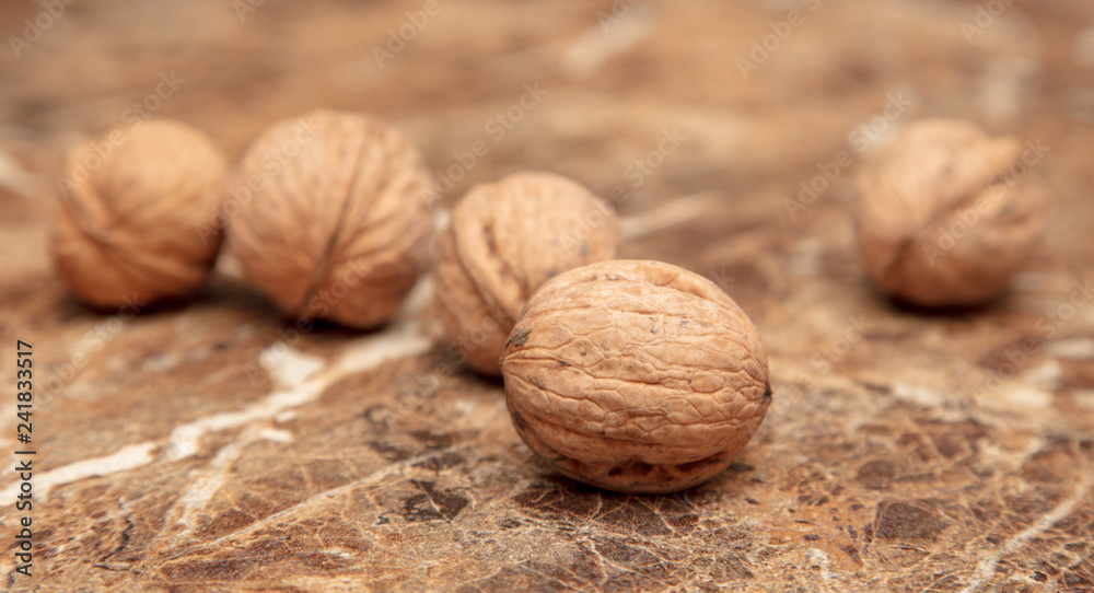 Walnuts on a marble table on the table Walnuts on a marble table on the table