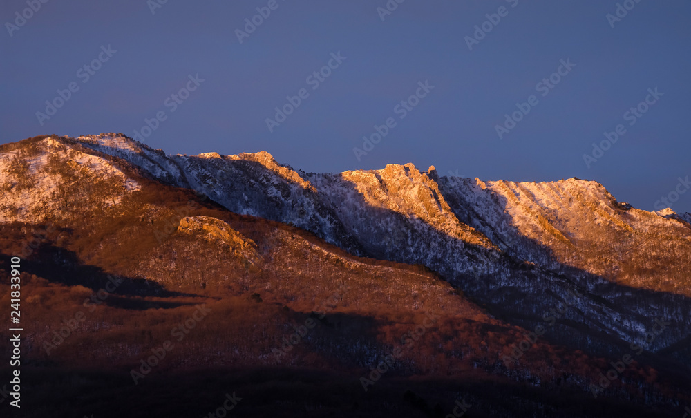 mountain range illuminated by the rising sun
