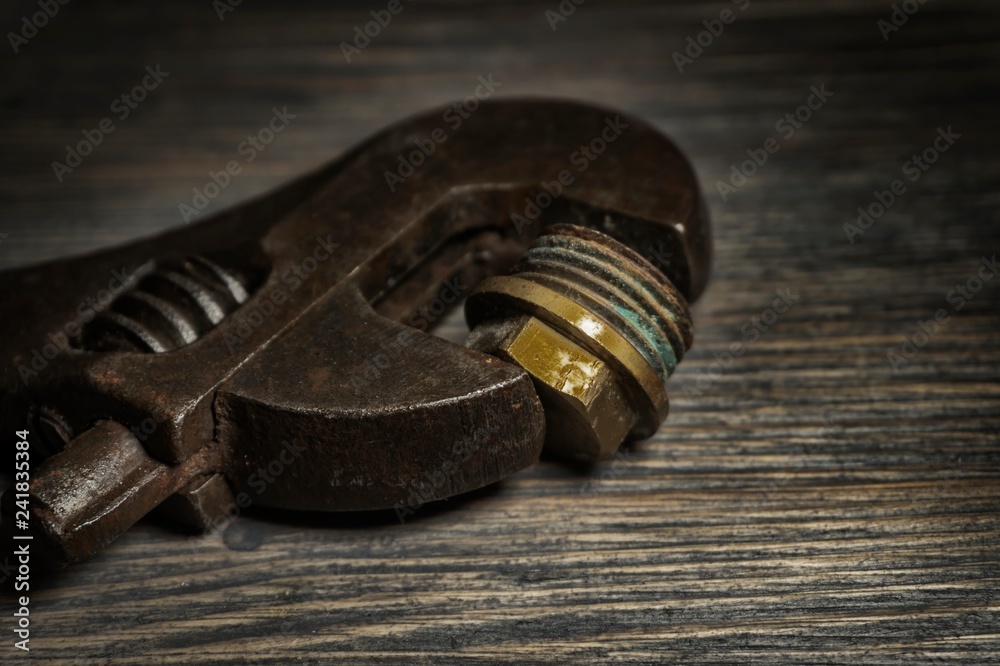 Adjustable wrench on a rustic wood background Adjustable wrench on a rustic wood background