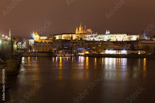 Night colorful snowy Christmas Prague Lesser Town with gothic Castle and Charles Bridge  Czech republic