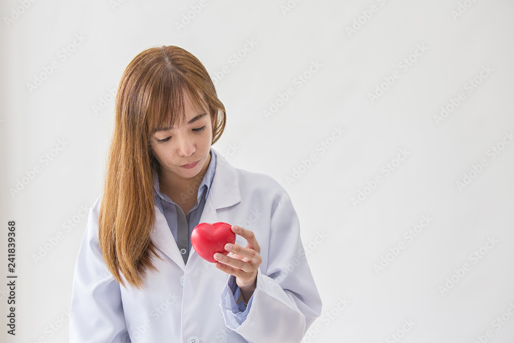 Portrait of smiling female doctor with red heart. Friendly young woman doctor with red heart on hand. asia. Portrait of smiling female doctor with red heart. Friendly young woman doctor with red heart on hand. asia.