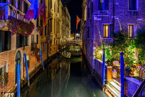 Narrow canal in Venice, Italy. Architecture and landmark of Venice. Cozy night cityscape of Venice.