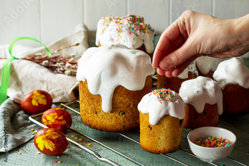 Cooking baking. Easter cake and painted eggs on white wooden table in rustic style.