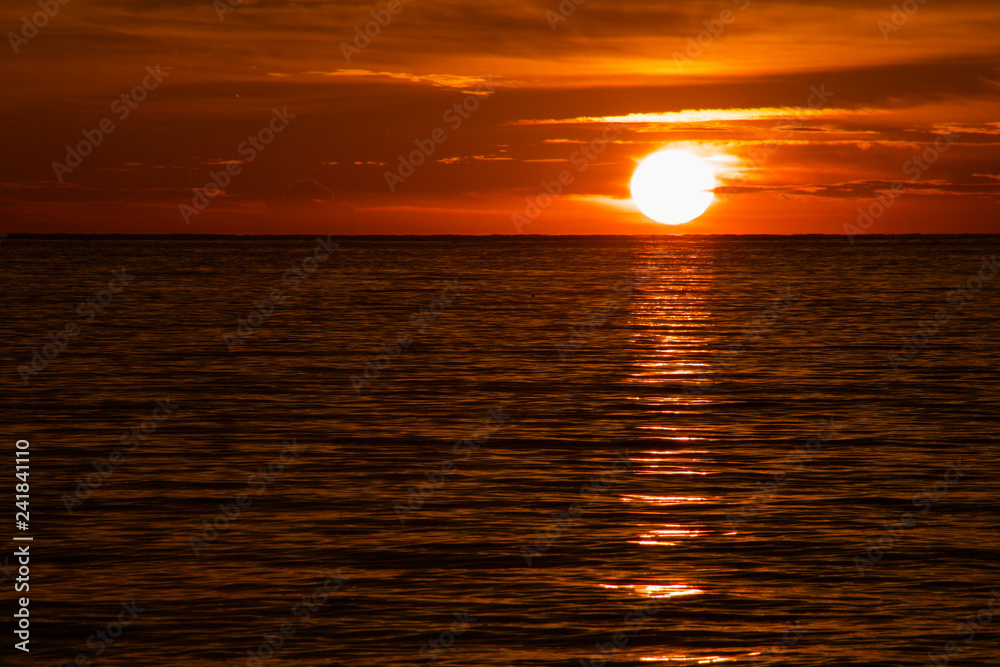 beautiful  tropical sunset on  the sea with reflections on the water