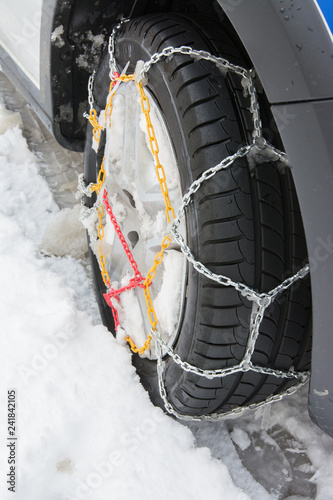 Tire With Mounted Snow Chains in the Winter Snowy Day