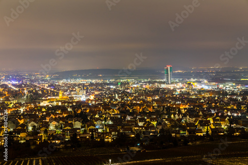 Germany, Bright city lights of fellbach houses in the night from above